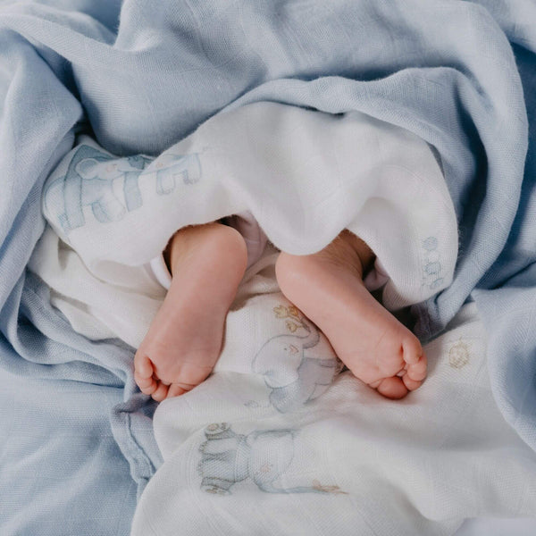 baby swaddle blankets 100% bamboo with blue elephant designs on a white background